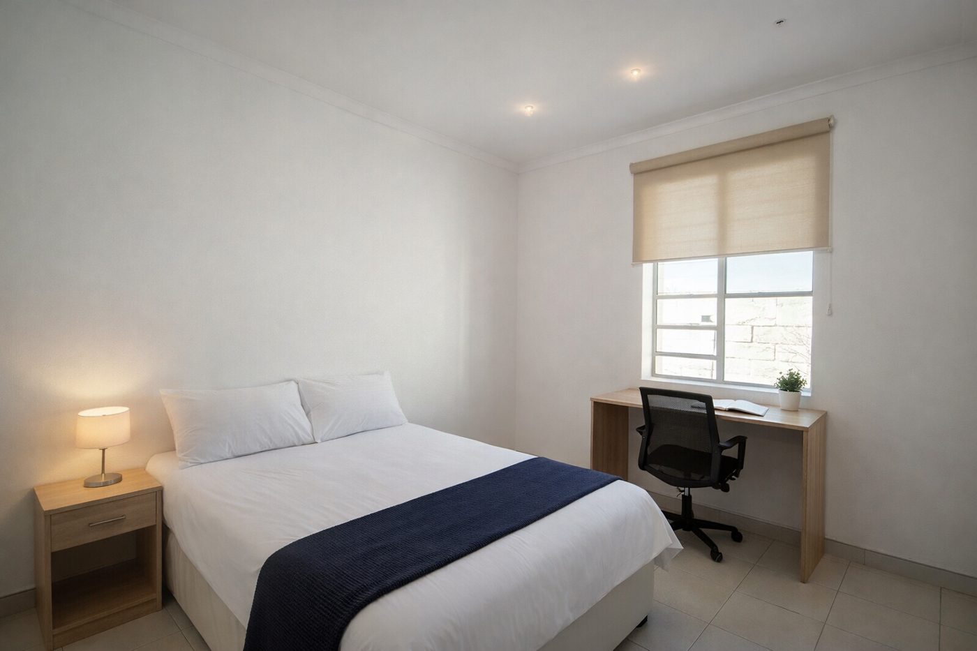 Furnished bedroom with study desk at Emerald Arc